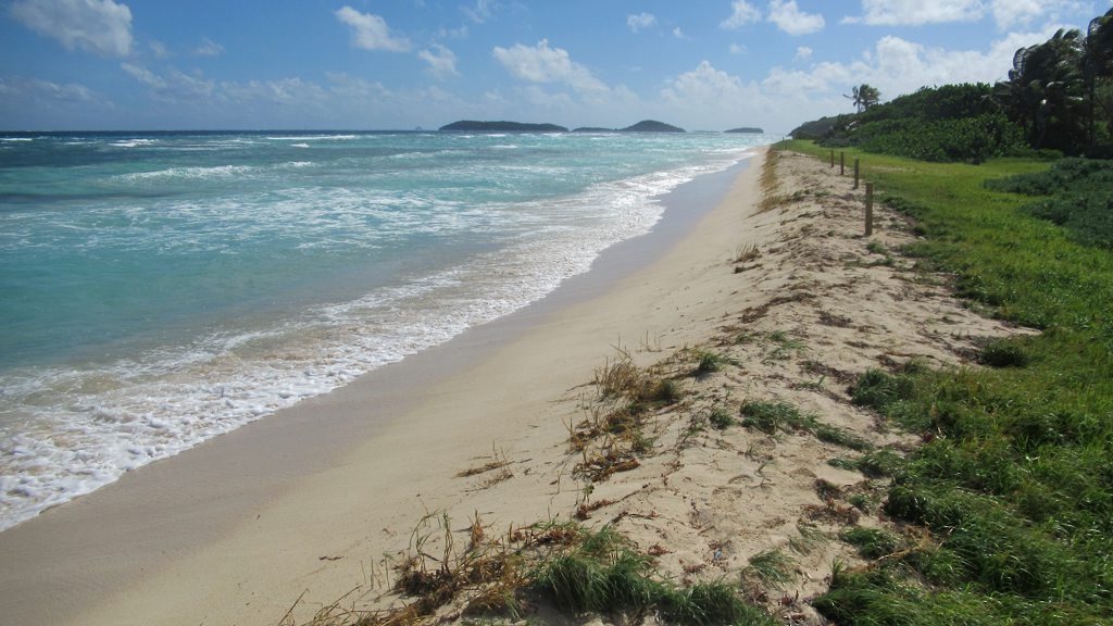 Windward beach on Mayreau with surf and the Tobago Cays on the horizon